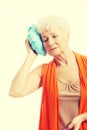 An old lady with ice bag by her head. Royalty Free Stock Photo