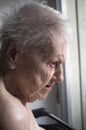 Old lady looking out window Royalty Free Stock Photo