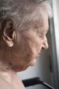 Old lady looking out window Royalty Free Stock Photo