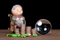 Old lady model and dollar coins and magnifying glass and capsule medicines in front of black background