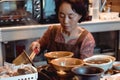 Old lady preparing tea the traditional Korean way in the old Insadong street in Seoul South Korea