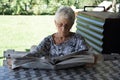 old lady reading the newspaper sitting in the garden Royalty Free Stock Photo