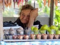 Old lady selling fruit and nuts in plastic cups in Georgia.