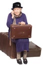 The old lady sits on a suitcase Royalty Free Stock Photo