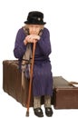 The old lady sits on a suitcase Royalty Free Stock Photo