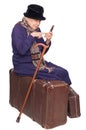 The old lady sits on a suitcase