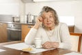 An old lady sitting at the kitchen table Royalty Free Stock Photo