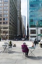 Old lady sitting at the table looking at a New York