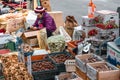 Old lady vendor selling chestnuts, ginger, fish and other goods on a street in Seoul South Korea