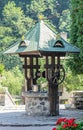 The old Lainici Monastery on a summer`s day, detail from the courtyard with exterior fountain.