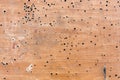 Old laminate Board with drill holes, paint and scuffs. Wooden old grunge background. Texture of dirty vintage laminate