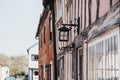 Old lamp on the exterior of half-timbered pastel pink medieval house in Lavenham, Suffolk, UK Royalty Free Stock Photo