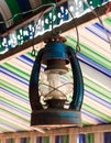 The old lamp hangs on beam colorful background.