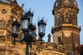 An old lamp post in from of the tower called Hausmannturm in Dresden, Germany, on a warm summer evening as the sun sets