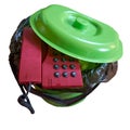 Old landline phone thrown into the trash bin. Isolated. White background Royalty Free Stock Photo