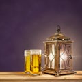 Old lantern with beer on purple vintage background