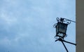 Old latern on the wall with background on the sky