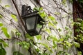 Old lantern hanging on a stone wall. antique retro lamp hang on home exterior. Grunge broken light source furniture wallpaper with