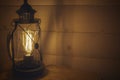 Old lantern hanging on a wooden wall Royalty Free Stock Photo