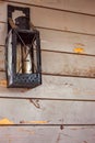 Old lantern hanging on the wooden wall Royalty Free Stock Photo