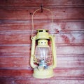 Old lantern hanging on a wooden wall Royalty Free Stock Photo