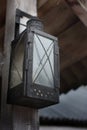 old lantern hangs on a wooden Board