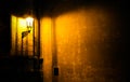 Old lantern illuminating a dark alleyway corner wall at night in Prague, Czech Republic