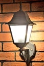 Old lamp in Victorian style on the brick wall Royalty Free Stock Photo