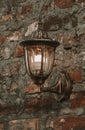 Old lantern on a stone wall Royalty Free Stock Photo