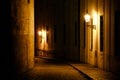 Old lanterns illuminating a dark alleyway medieval street at night in Prague, Czech Republic. Royalty Free Stock Photo