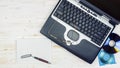 Old laptop with a laser disk, calculator, notebook, glasses and Royalty Free Stock Photo