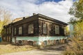 An old large abandoned log mansion in a city manor