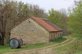 Old large barrel in front of ancient stone house Royalty Free Stock Photo