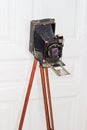 Old large format photographic camera with bellows on wooden trip Royalty Free Stock Photo