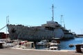 Rusted and beaten down ship docked in harbor