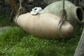 Old large jugs of wine, clay qvevri amphora lie on the grass, Royalty Free Stock Photo