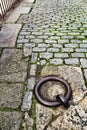 Old large rusty metal ring for mooring boats in the river