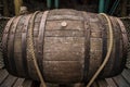 Large wine wooden barrels on a wooden floor tied with a large rope