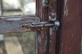 Old latch on the abandoned glass door