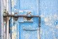 Old latch on a wooden blue door in Tuscany, Italy Royalty Free Stock Photo