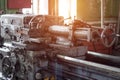 Old lathe at the enterprise, a sunset comes through the window, workshop Royalty Free Stock Photo