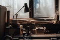 Old lathe on metal and wood in abandoned carpentry. dirt, dust and cobwebs on the windows