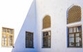 Old lattice windows in the white wall in inner yard of the ancient Ark of Bukhara, Uzbekistan.