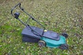 Old lawnmower on green grass Royalty Free Stock Photo