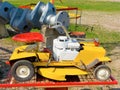 An old lawnmower and a used crankshaft on display in canada