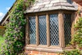 Garden house leaded window with old wooden frame.