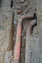 Old leaky pipes in the pit. Preparation for pipe replacement Royalty Free Stock Photo