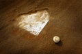 Old Leather Baseball on Field by Home Plate or Base Royalty Free Stock Photo