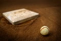 Old Leather Baseball on Field by Home Plate or Base Royalty Free Stock Photo