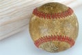 Old Leather Baseball Up Close Detail Next to a Wood Bat Royalty Free Stock Photo